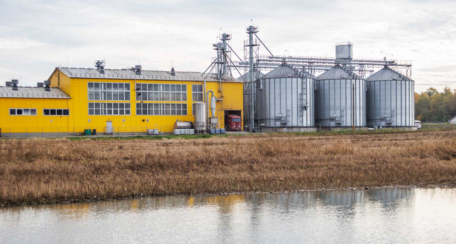  Warehouses and silos at a farm located on a river in West Africa