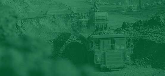 Excavator loading a truck at a mining site