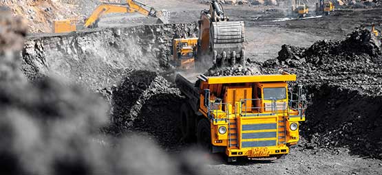 Excavator loading a truck at a mining site