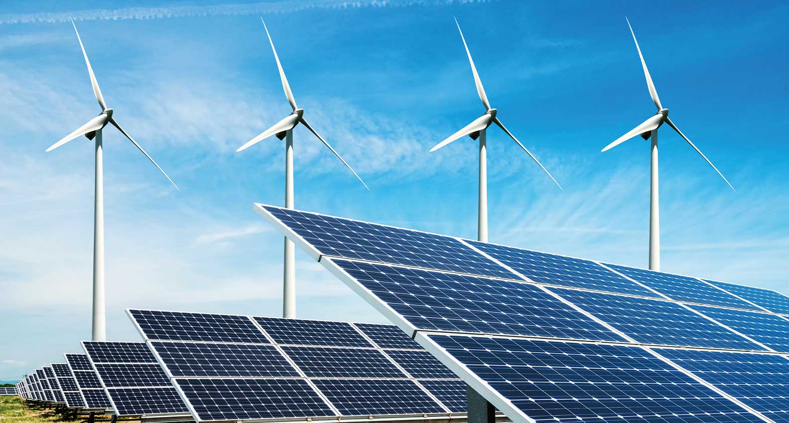 Solar panels and wind turbine against a blue sky in Africa