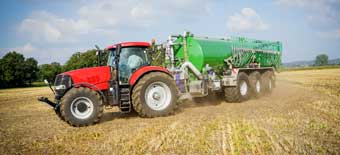 Wendit Agricultural Technology Division: Tractor with trailer fertilizing a harvested field